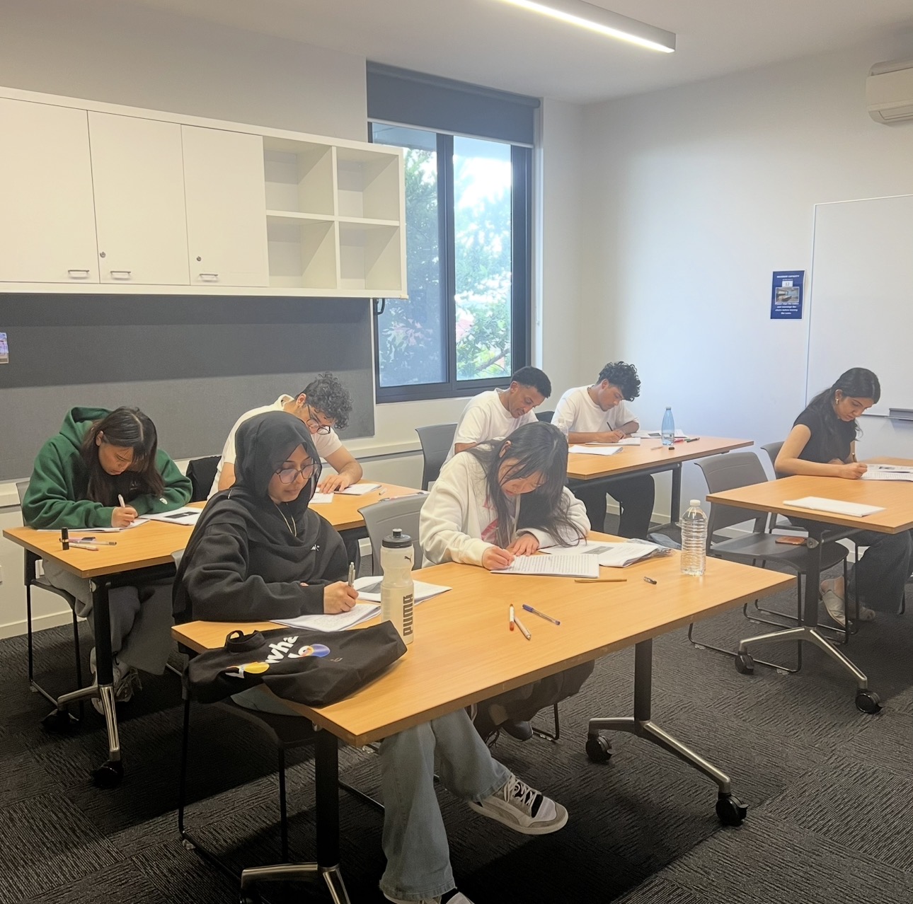 Students completing timed practice papers in class