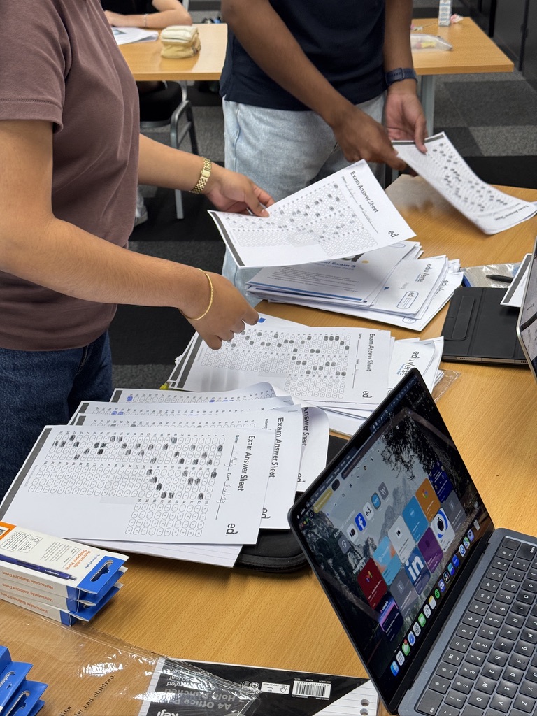 Tutors reviewing completed answer sheets